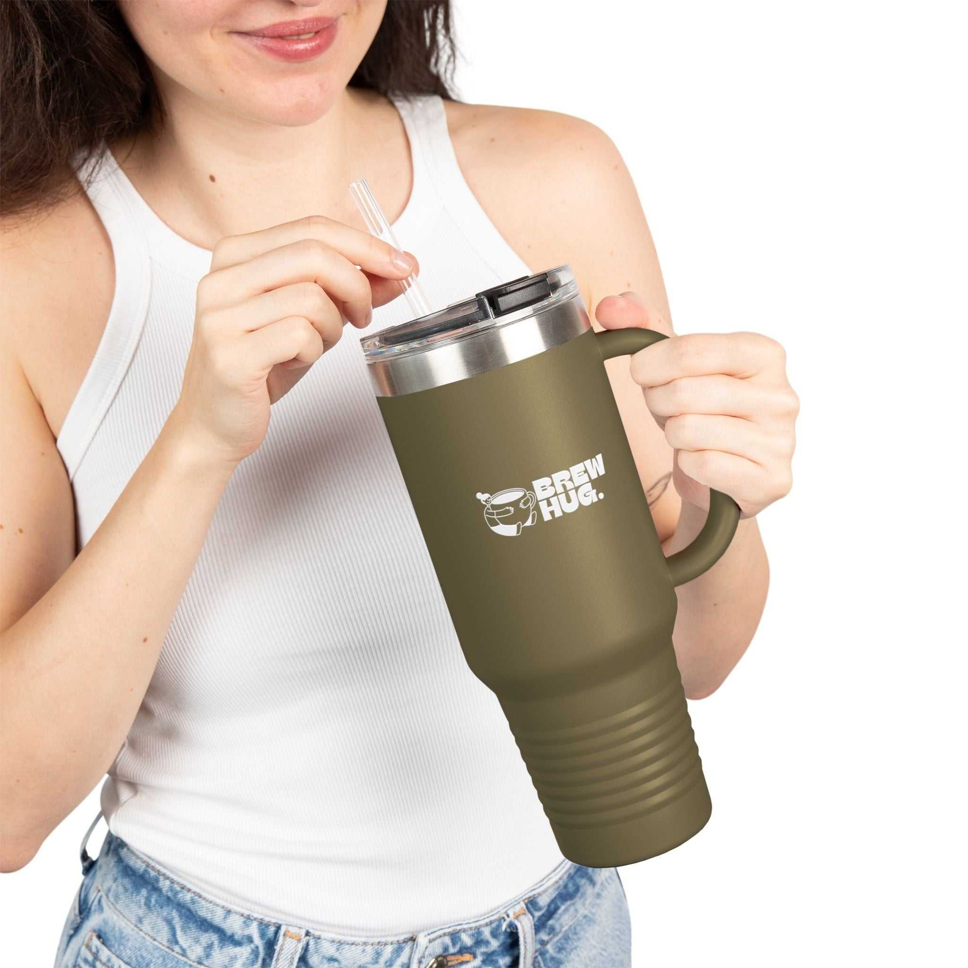 Person holding a green travel mug with 'Brew Hug' logo on a white background