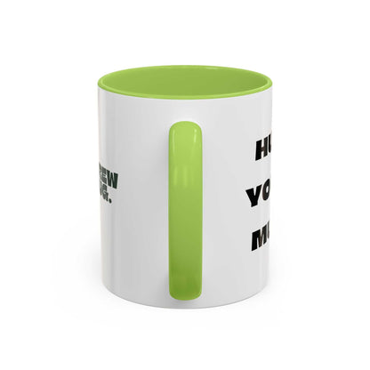 White mug with green interior and handle, featuring text on a white background
