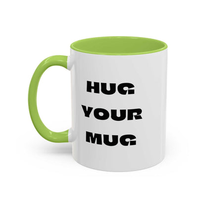 White mug with green handle and interior, featuring 'HUG YOUR MUG' text.